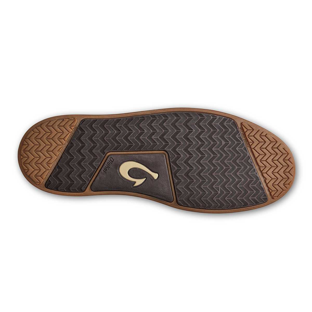 Sole of dark brown shoe with geometric tread pattern, tan heel and toe sections, and curved logo patch in center.