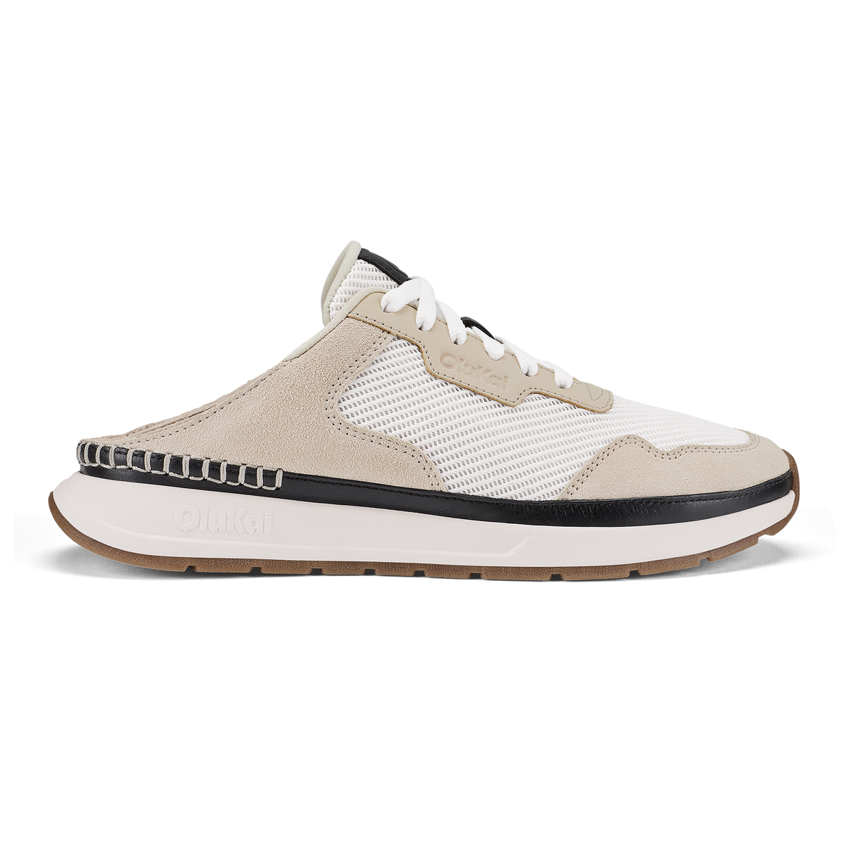Mule-style sneaker in bright white and ecru with black trim, mesh and suede upper, and tan rubber sole.