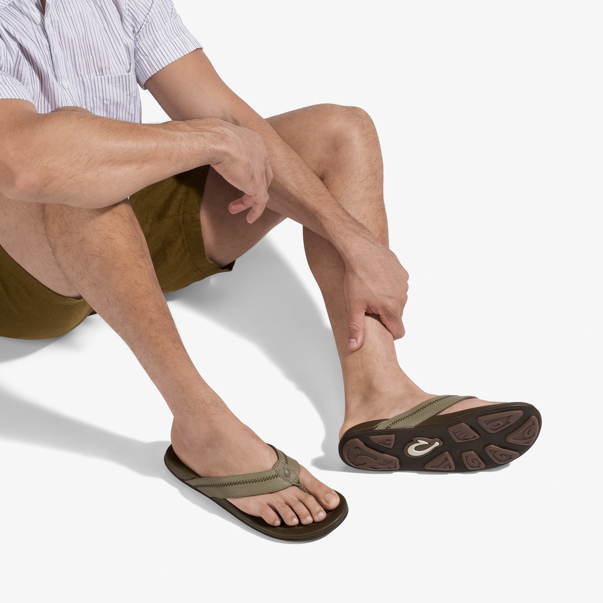 Man wearing clay and mustang colored sandals with brown sole and tan fabric straps.