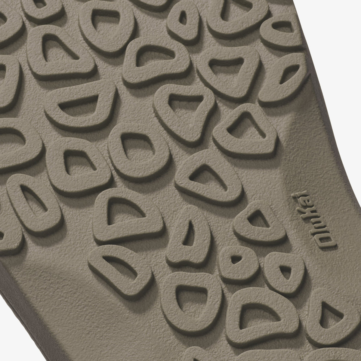 Tan clay tile with embossed repeating curved pattern and brand name visible on surface.