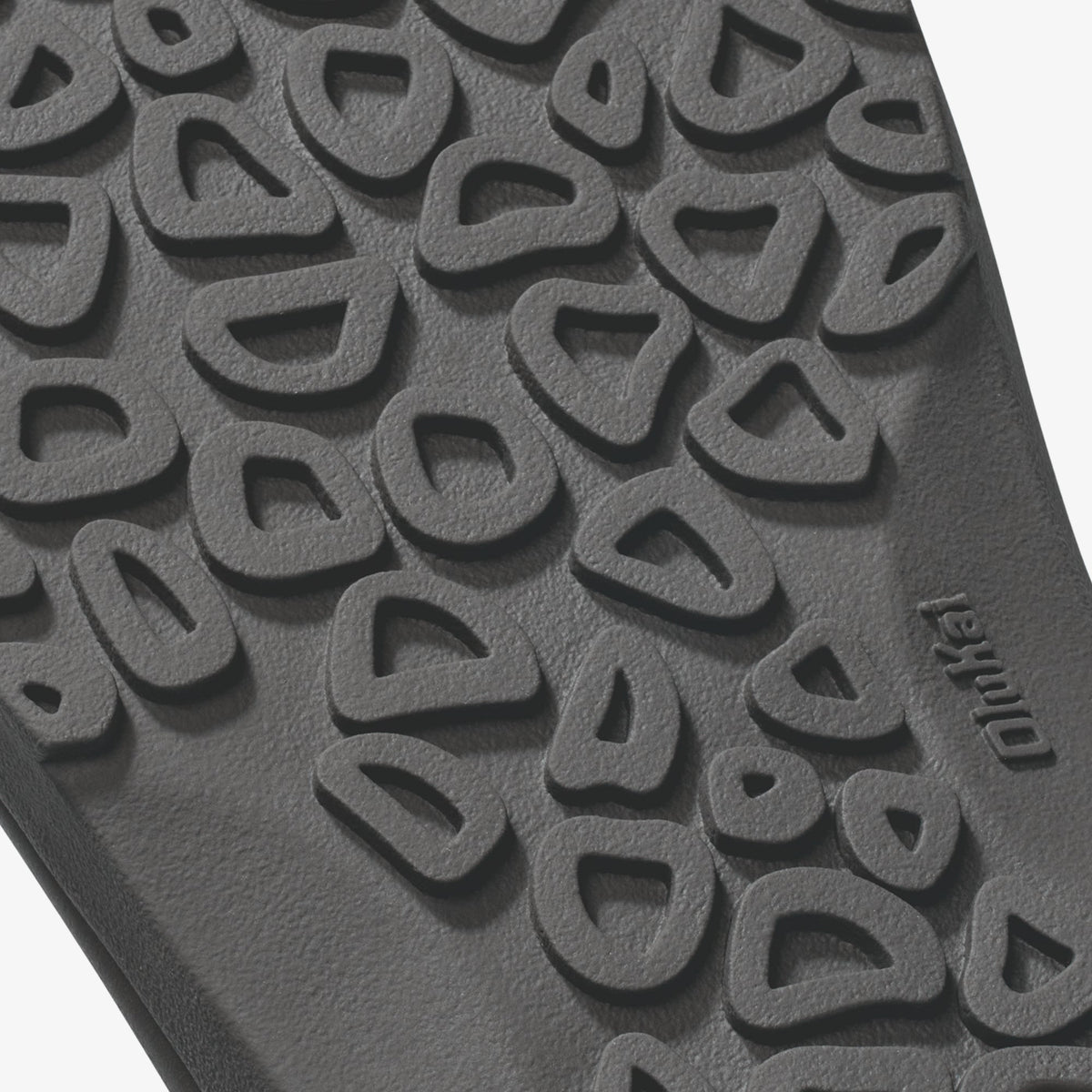 Gray rubber sole with textured tread pattern and curved geometric designs throughout.