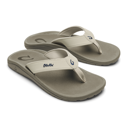 Pair of beige and gray thong sandals with cushioned soles and branded toe straps.