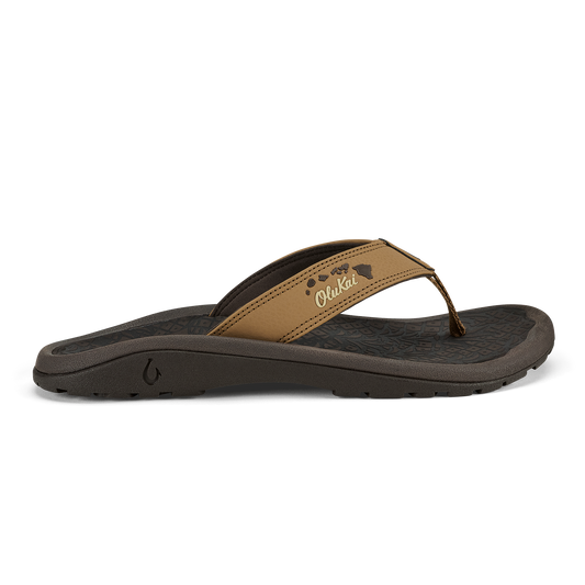 Tan leather thong sandal with black sole and island chain design detail on strap.