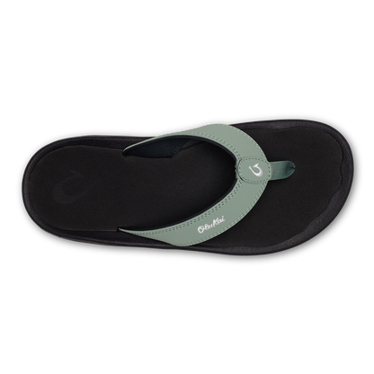 Seagreen and black thong sandal with cushioned black footbed and adjustable seagreen strap with button closure.