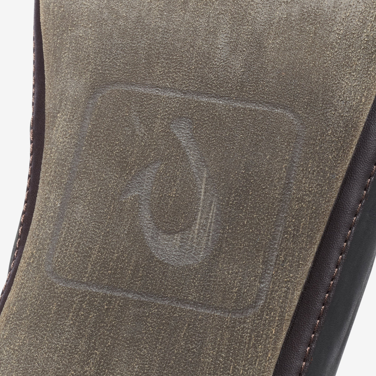 Black and dark brown slipper with textured suede upper and contrasting stitched side seam.