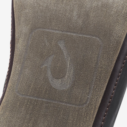 Black and dark brown slipper with textured suede upper and contrasting stitched side seam.