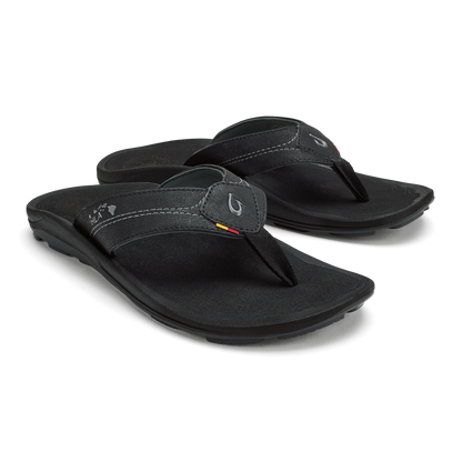 Black flip-flops with contoured footbeds and thong straps featuring contrast stitching and logo detail.