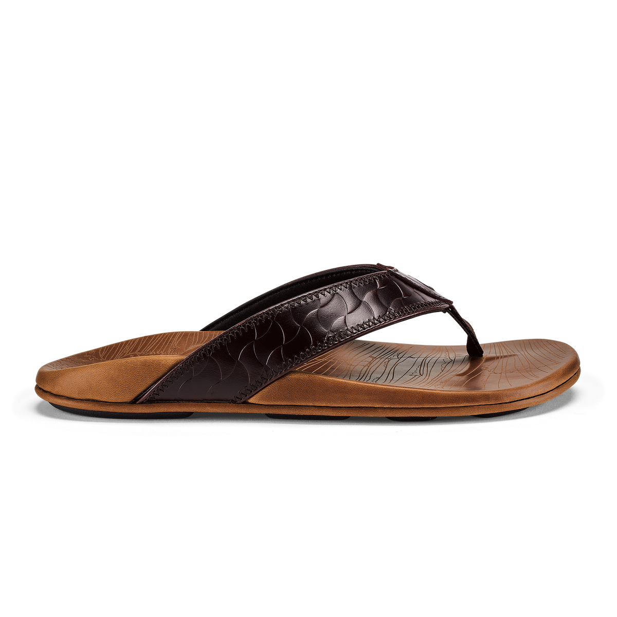 Thong sandal with dark brown quilted upper strap and tan leather footbed against white background.