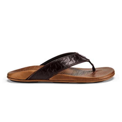 Thong sandal with dark brown quilted upper strap and tan leather footbed against white background.