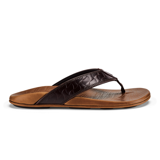 Thong sandal with dark brown quilted upper strap and tan leather footbed against white background.