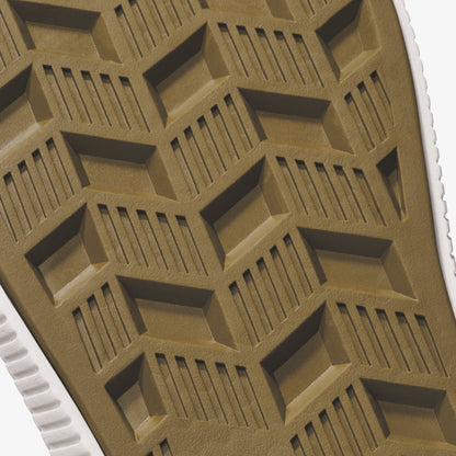 Tan and white shoe sole with geometric tread pattern featuring rectangular blocks and linear grooves.