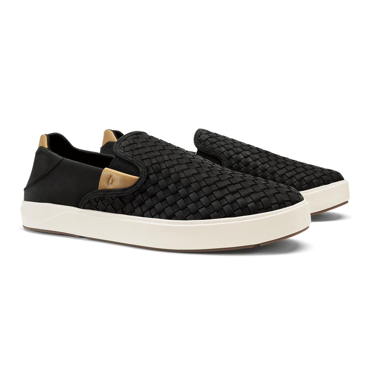 Black woven slip-on sneaker with cream sole and tan heel patch.