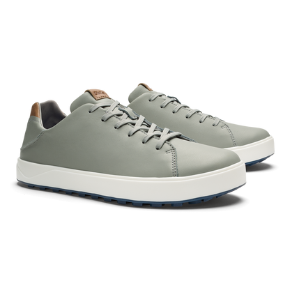 Grey lace-up sneaker with white platform sole and tan heel patch, shown from side angle.