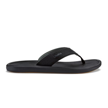 Black lava rock flip-flop sandal with textured strap and flat sole against white background.