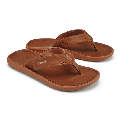 Pair of brown leather flip-flops with perforated straps and cushioned soles.