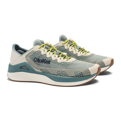 Pair of seagreen and white sand running shoes with yellow laces and brown heel accent.