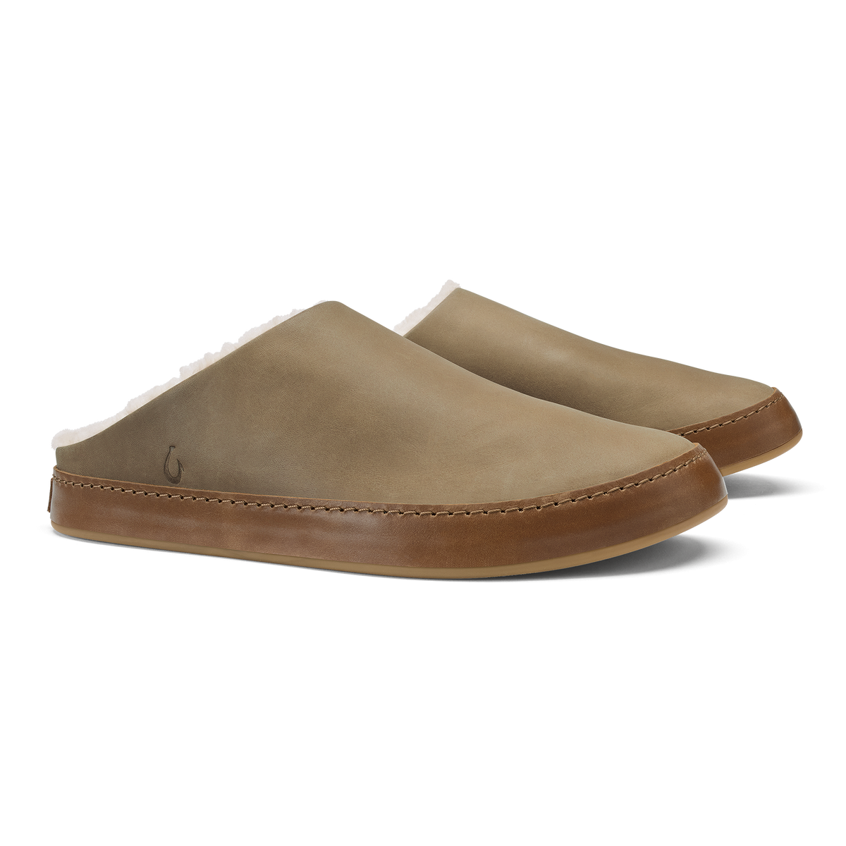 Pair of tan and brown mule slippers with stitched leather trim and rounded toe design.