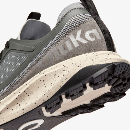 Grey and cream athletic shoe with speckled midsole, black outsole, and ASICS branding visible on the heel.