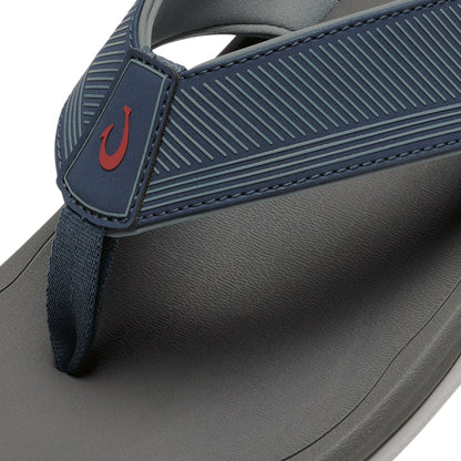 Coastal blue and dark shadow thong sandal with red hook logo and textured straps.