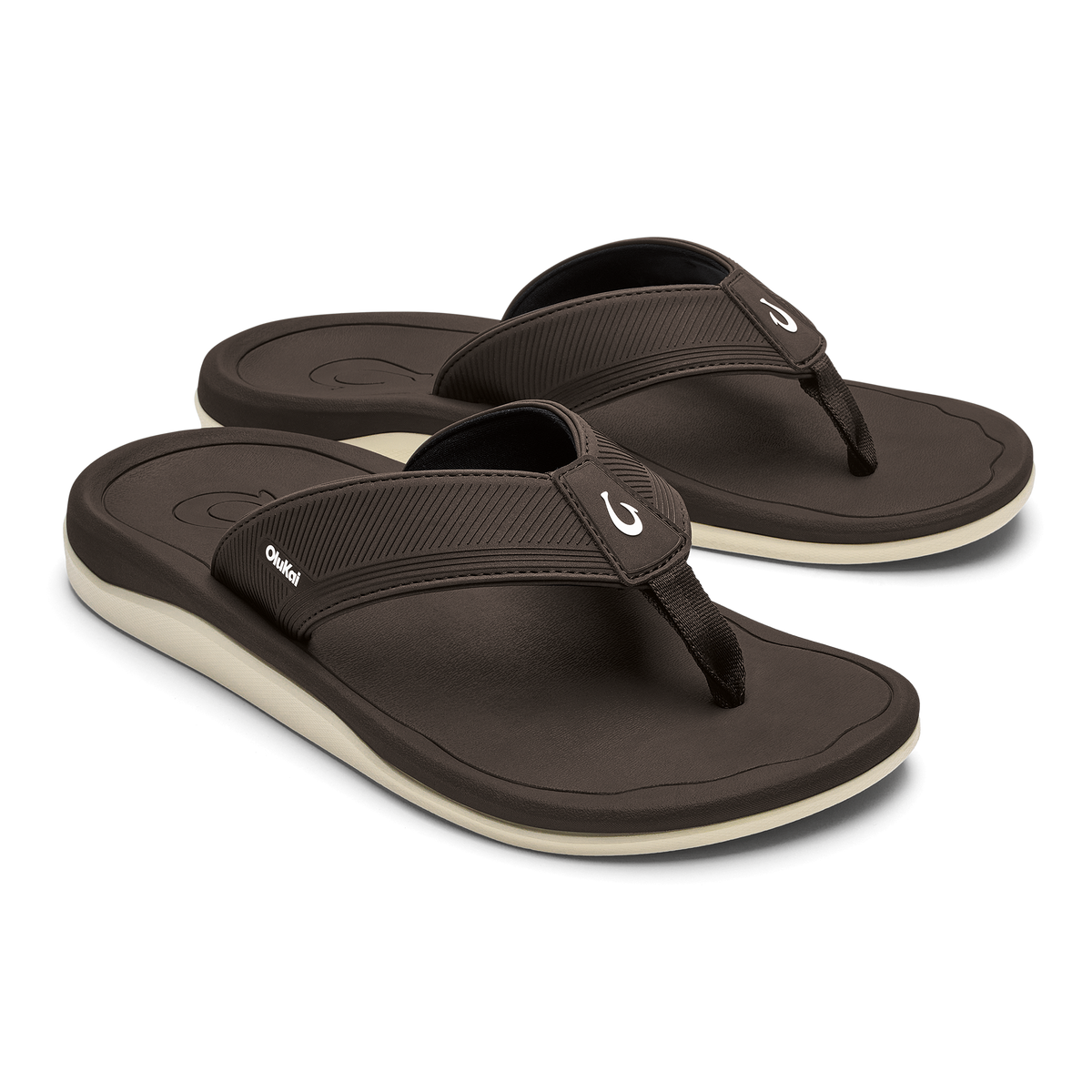 Pair of dark brown flip-flops with ribbed black straps and cream-colored soles.