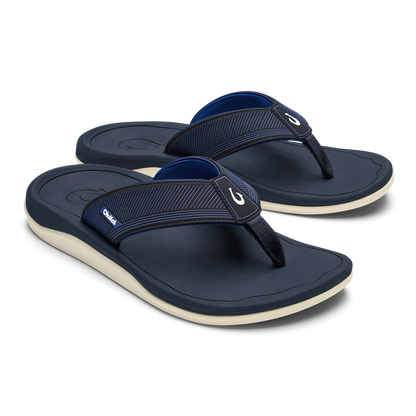 Pair of dark blue thong sandals with ribbed straps and cream-colored soles.
