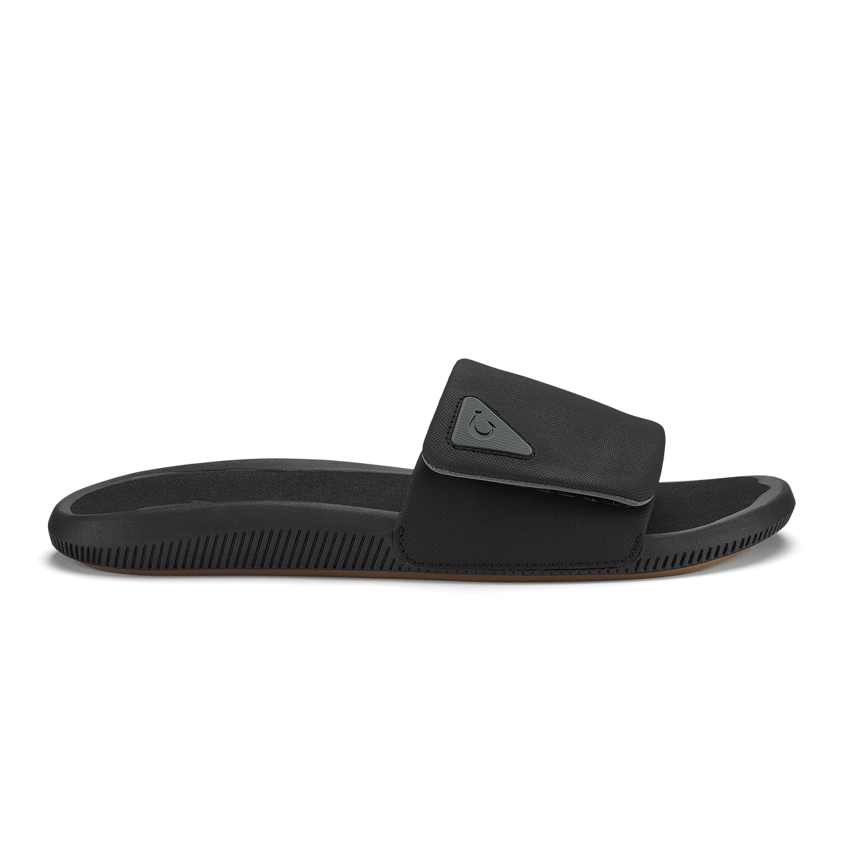 Black slide sandal with textured sole and adjustable padded strap across the foot.