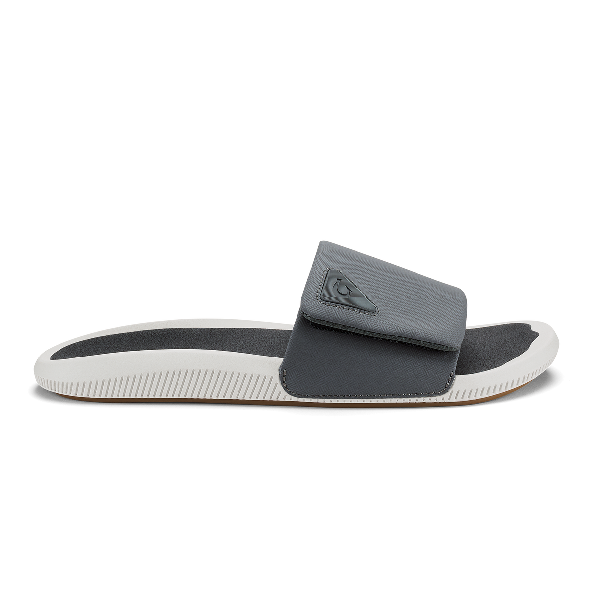 Gray and white slide sandal with padded upper and textured sole.