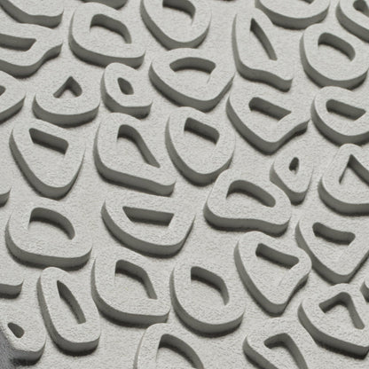 Close-up of light grey textured shoe sole with curved tread pattern and oval cutout designs.