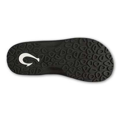 Black sandal sole with geometric tread pattern and white curved logo detail.