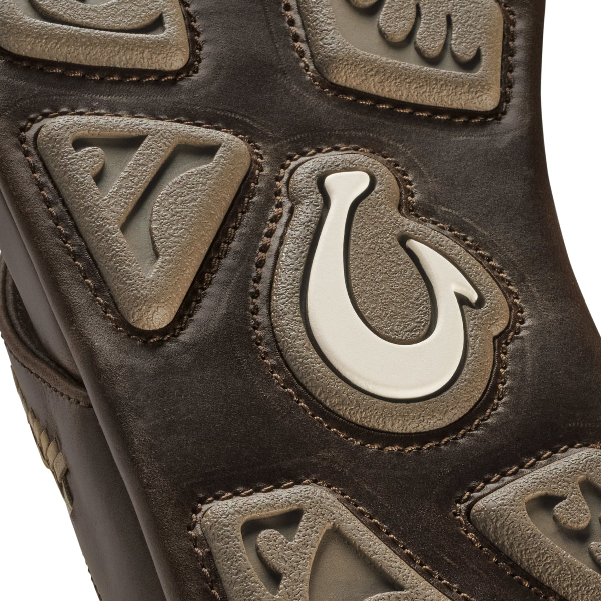 Dark brown suede leather with embossed geometric patterns and cream-colored decorative inlays.