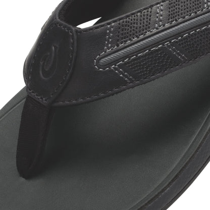 Black thong sandal with textured upper strap and cushioned footbed, shown from above.