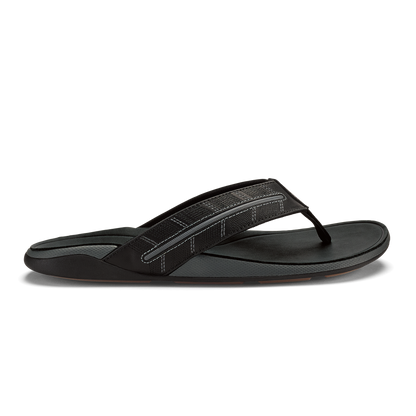 Black thong sandal with textured upper strap and flat sole, shown in profile view.