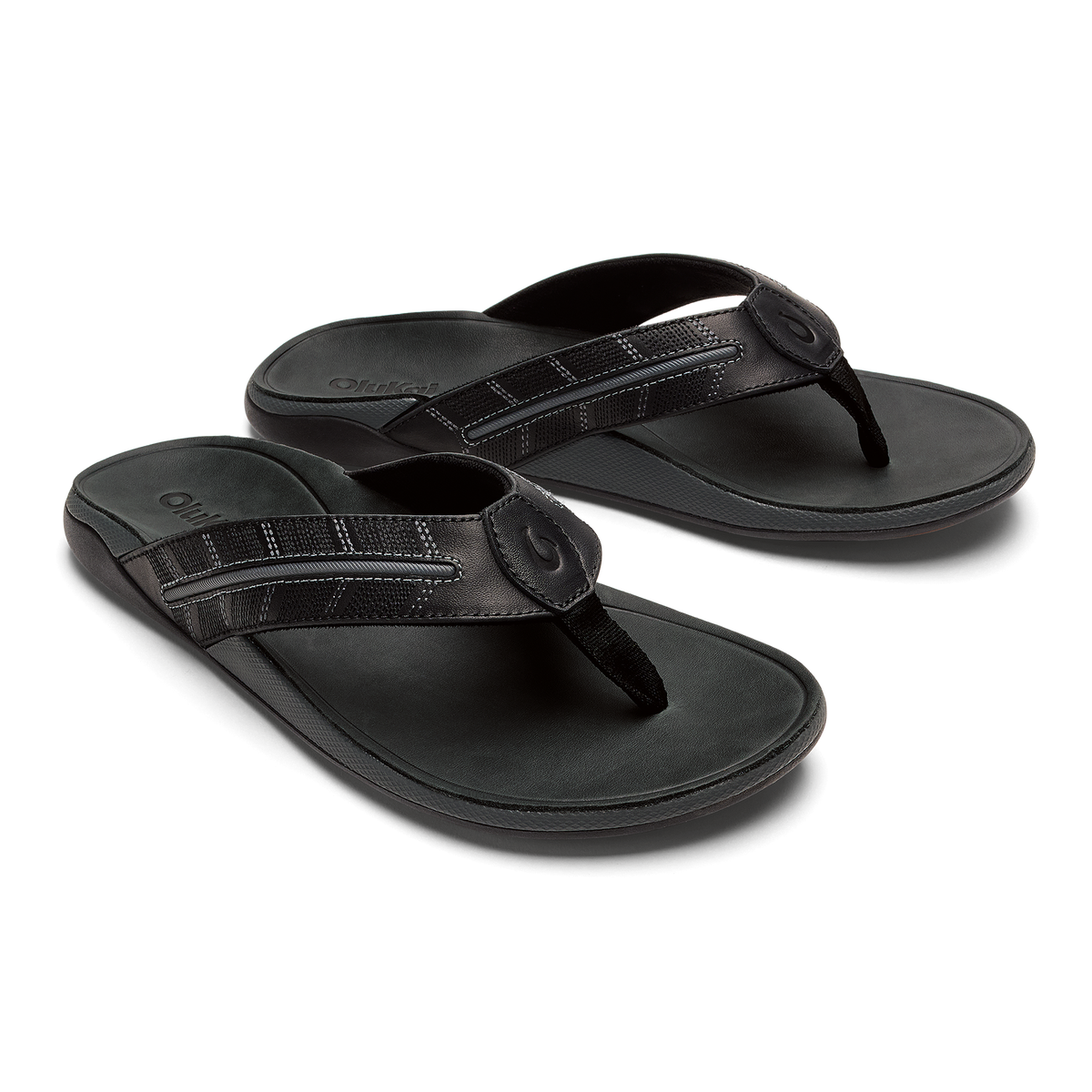 Pair of dark gray flip-flops with textured straps and circular toe post closures, shown from above.