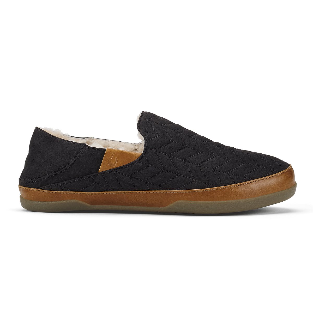 Black quilted slip-on shoe with tan leather trim and cream fleece lining.