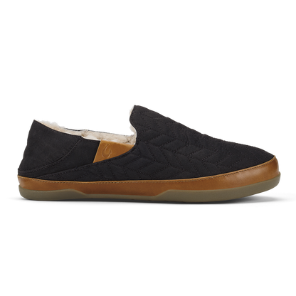 Black quilted slip-on shoe with tan leather trim and cream fleece lining.
