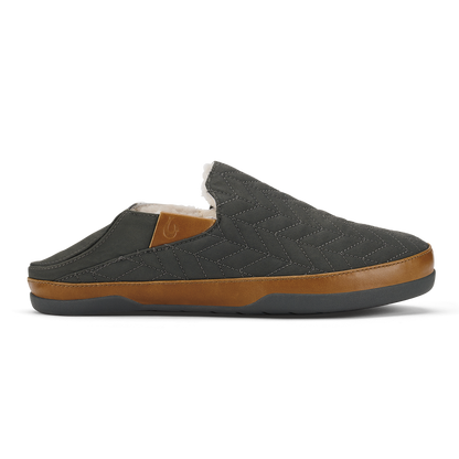 Dark gray quilted slip-on slipper with tan leather trim and fleece lining, shown from the side.