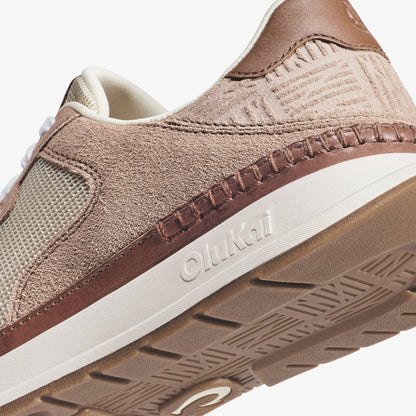 Taupe and cream sneaker with textured suede upper, white midsole, and embossed tread sole detail.