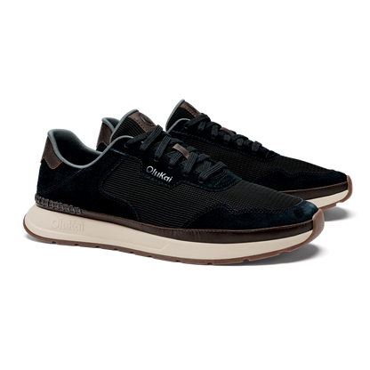 Black lace-up sneaker with textured upper, cream midsole, and brown trim accents.