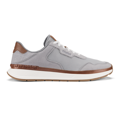 Light grey and brown sneaker with mesh upper, white laces, and cream-colored sole.