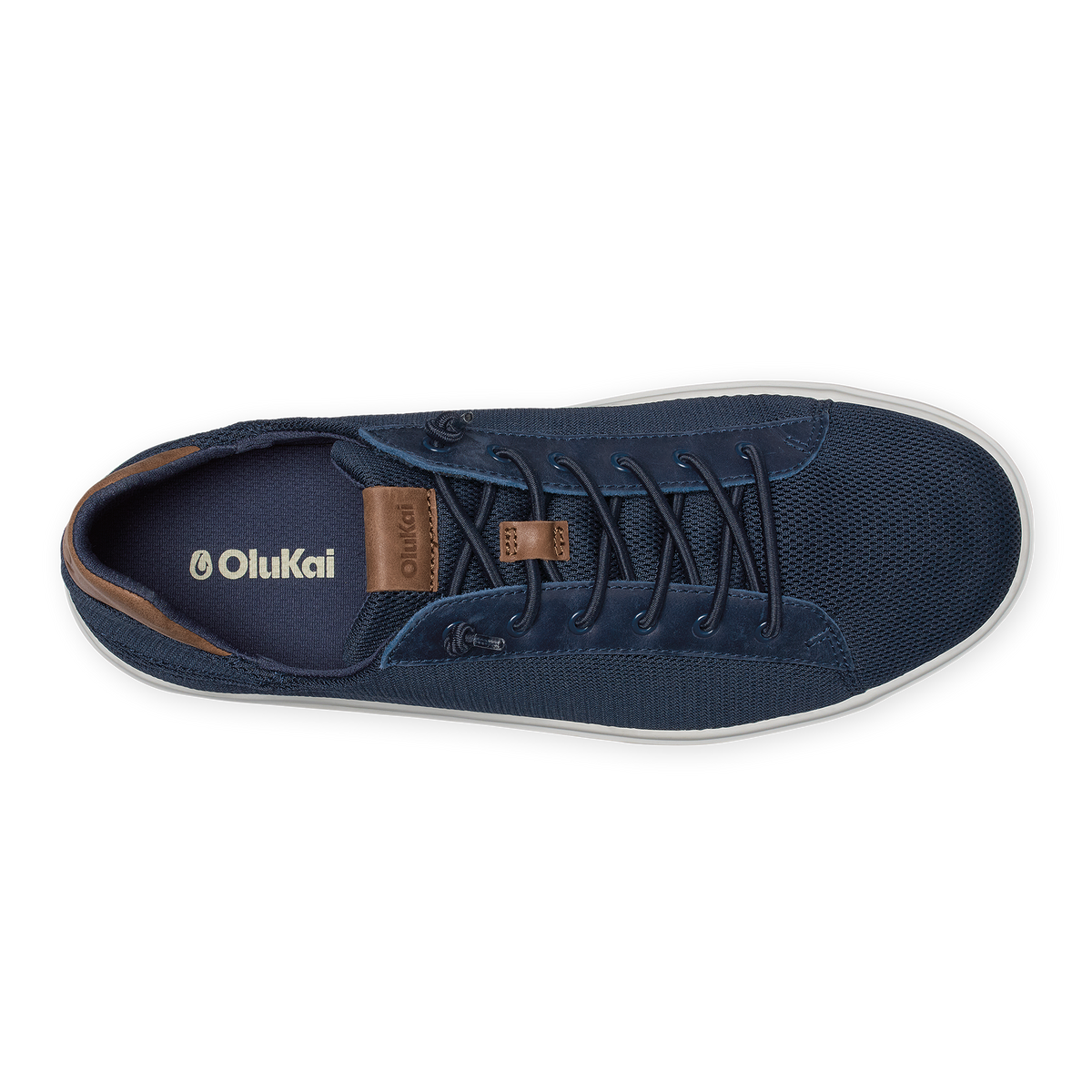 Navy blue canvas sneaker with brown leather accents, dark laces, and white sole, viewed from above.