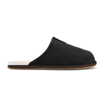 Black slipper with cream-colored inner lining, brown sole, and small emblem on the upper.