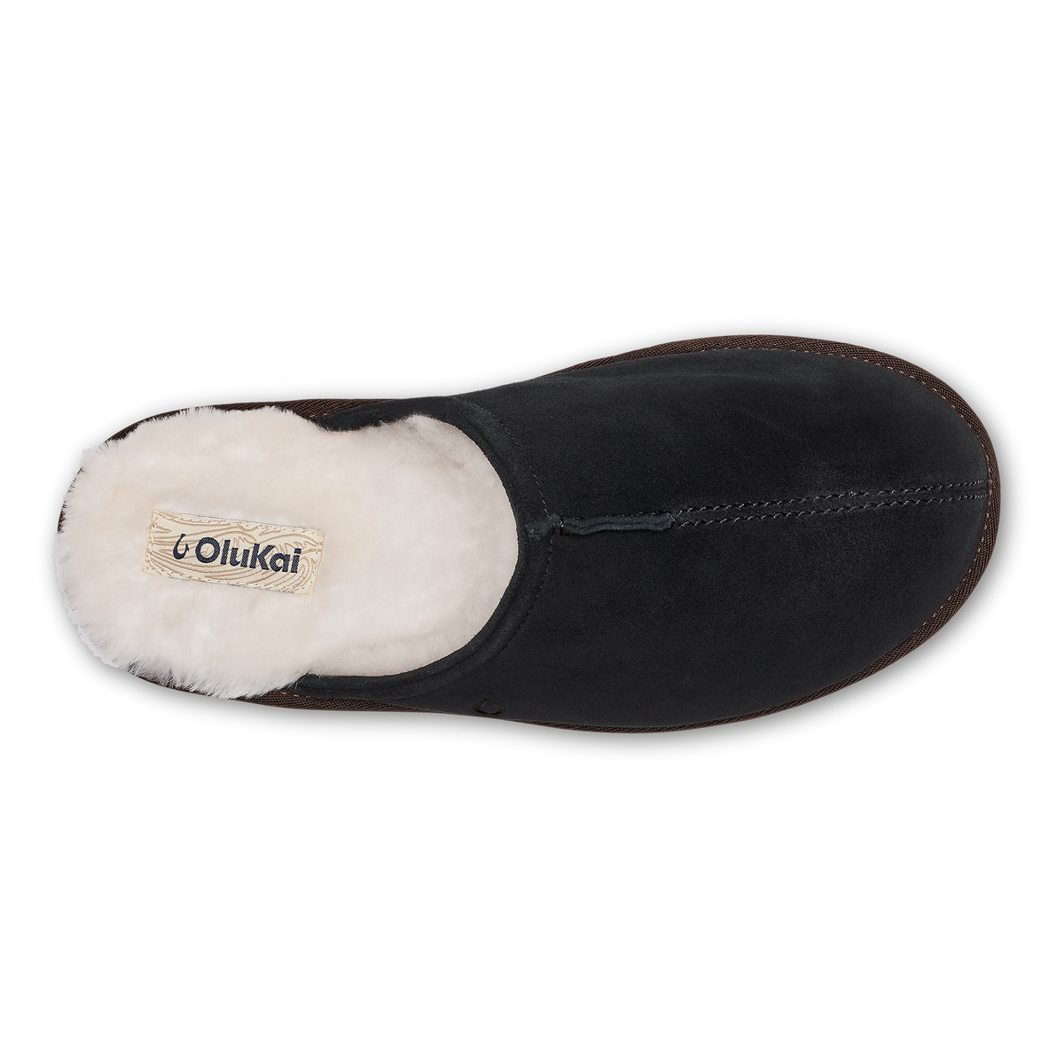 Black suede slipper with cream fleece lining and visible OluKai brand label, top view.