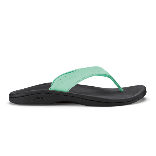 Black and mint green flip-flop sandal with curved sole and padded footbed.