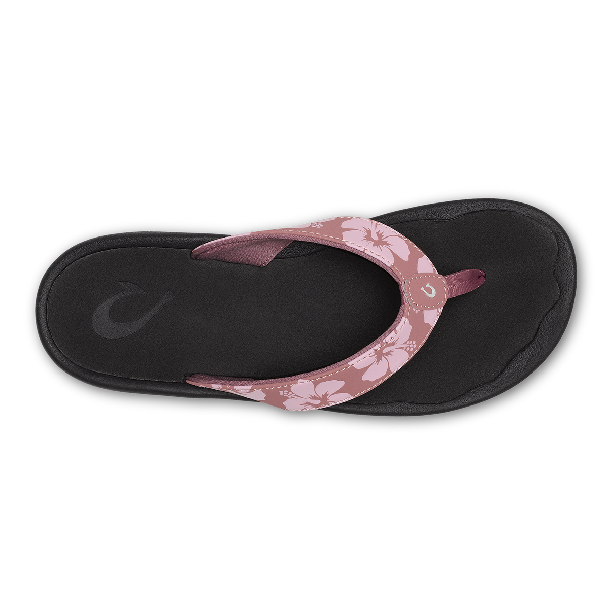 Flip-flop with black sole and coral rose strap featuring white hibiscus flower pattern, overhead view.
