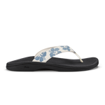 White and blue floral thong sandal with black sole and curved footbed.