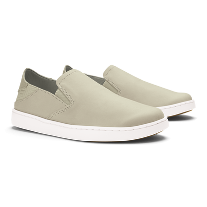 Beige leather slip-on sneakers with white sole and stitched detailing, shown from a three-quarter angle.
