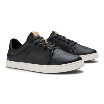 Black leather sneakers with cream rubber sole and tan heel collar detail, shown from side angle.