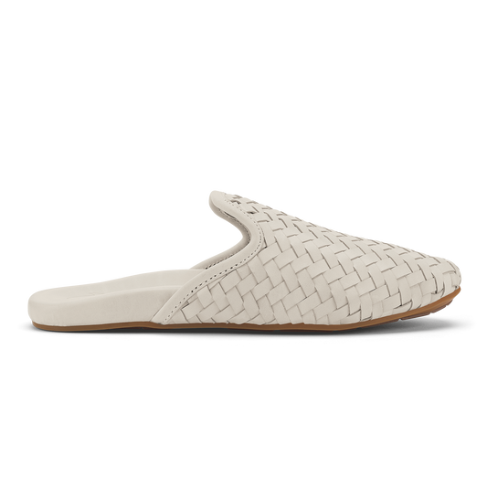 Cream-colored woven leather mule slipper with tan sole, shown in profile view.