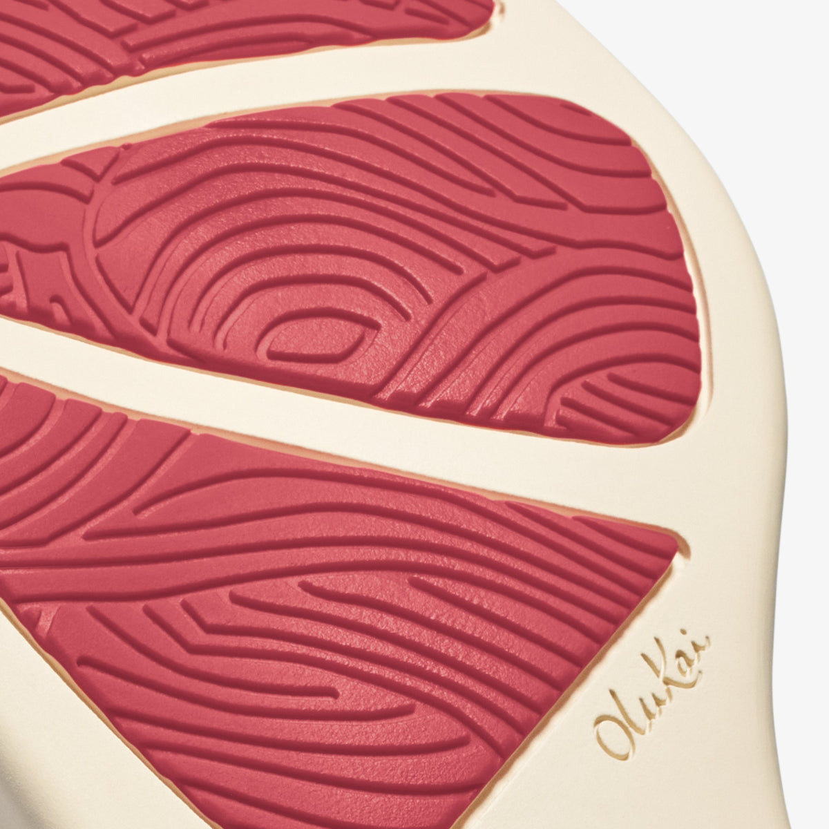 Hot pink leaf-shaped object with textured vein patterns on cream-colored background.