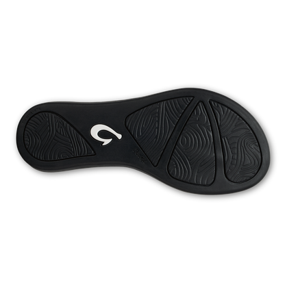 Black sandal sole with textured tread pattern and white logo detail.